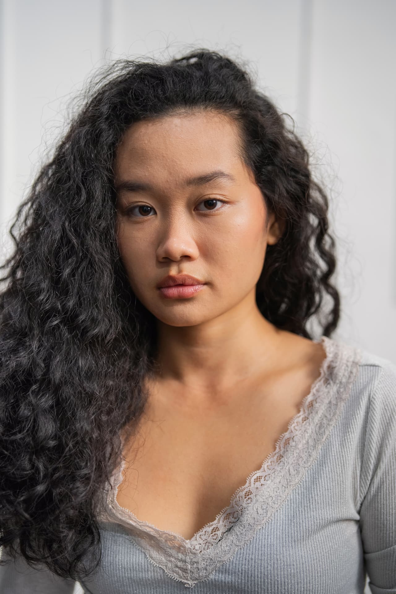 Amelia Ali intimate close-up portrait with curly hair and soft light